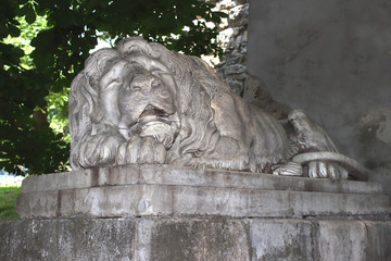 White stone statue of a sleeping lion. Ancient monument of architecture. Beautiful texture for a computer game