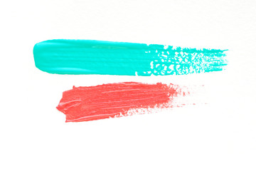 .strokes of mint blue and coral acrylic paint. place for text. isolate on a white background..