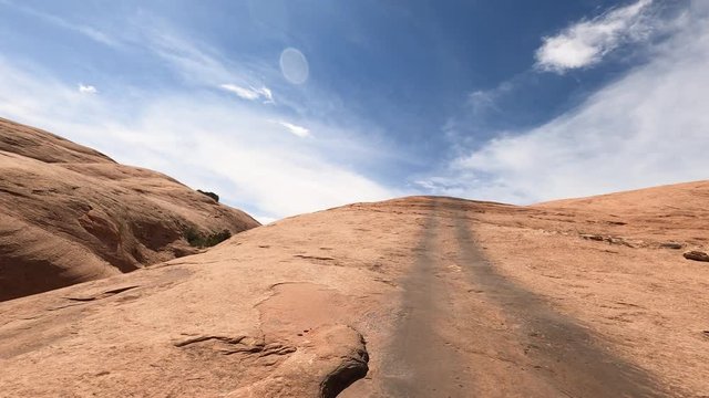 Off road recreation steep climb slick rock Moab Utah desert. Desert. Tourists visitors worldwide visit Arches and Canyonlands National Parks. Recreation, 4x4 red slick rock trail climbing exploring.