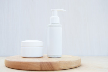 Isolated SPA cosmetic products, a jar with a dispenser and a cream jar on wooden board on a white background. Branding layout, mock up.
