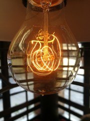 Close up of light bulb with intense light wires