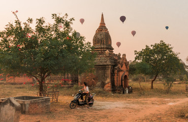 Woman rides a byke to visit temples in Bagan, Myanmar