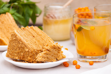 Tea with sea buckthorn, mint, honey, cinnamon, honey layered cake medovik.