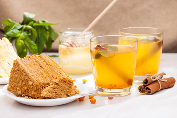 Tea with sea buckthorn, mint, honey, cinnamon, honey layered cake medovik.
