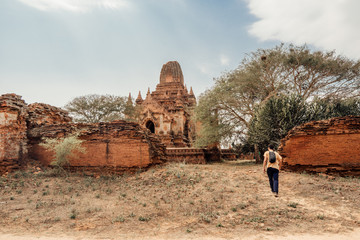 Tourist walks around the ruins of a temple in Bagan, Myanmar