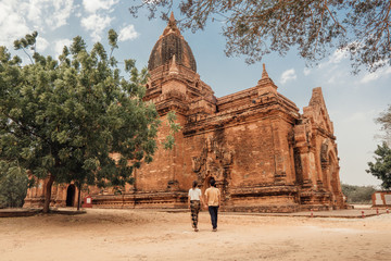Couple walks around a temple in Bagan, Myanmar