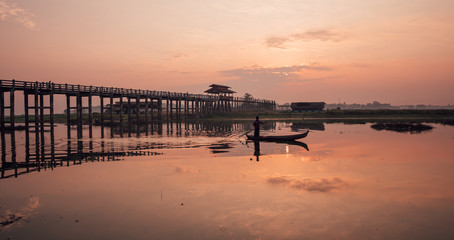 Naklejka na ściany i meble Fisherman crosses a river around U-Bein Bridge, Myanmar, Burma