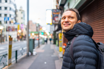 Tokyo, Japan Shinjuku sidewalk in morning by Okubo station area road street and tourist foreigner person people walking by restaurants shops in urban area