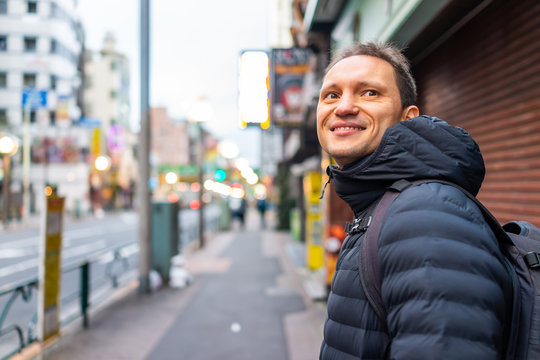 Tokyo, Japan Shinjuku sidewalk in morning by Okubo station area road street and tourist foreigner person people walking by restaurants shops in urban area