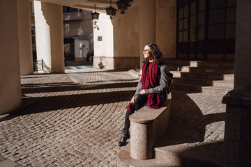 Young beautiful pretty girl walking along the street with handbag.