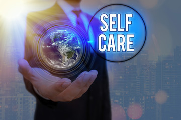 Writing note showing Self Care. Business concept for the practice of taking action to improve one s...
