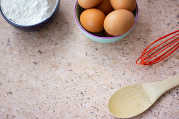 Kitchen utensils for cooking, eggs and flour in bowl