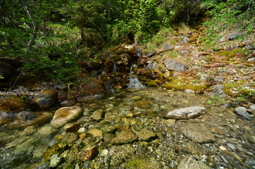 crystal clear water with a small waterfall in nature