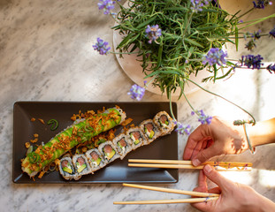 Homemade sushi on a plate puting sticks