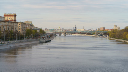 Naklejka premium Moskva River embankment, Gorky Park is popular for walking. Coronavirus pandemic. Rest for nature. Peter the Great Statue, Kremlin, Andreevsky (Pushkinsky) pedestrian bridge in distance