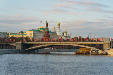 Moscow cityscape in spring. Kremlin wall, Towers, Residence of President of the Russian Federation, Ivan the Great Bell Tower, Dormition Cathedral, Bolshoy Kamenny Bridge is decorated by red flags