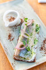 Rye Bread Sandwich Smorrebrod with Herring, Potato and Pickled Onion