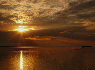 Sunset over the sea. Little island in the Lake. Wonderful view at sunset near the sea.