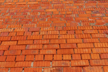 Red brick wall texture. Old retro building background copy space. Orange bricks surface, detailed stones backdrop. Desktop wallpaper textured screensaver. Front view.