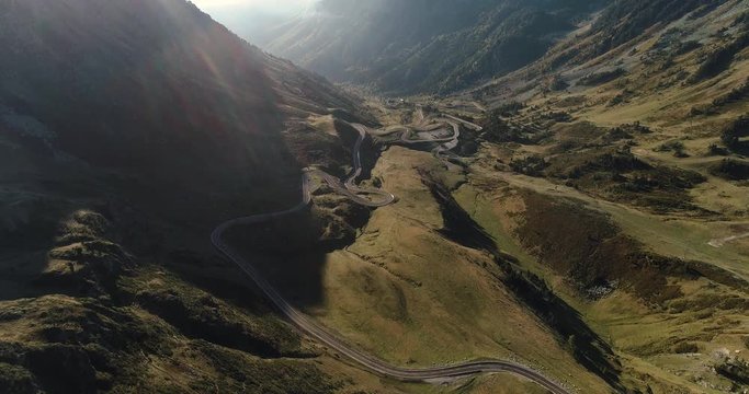 Summertime in huge valley with road winding up side of the mountain