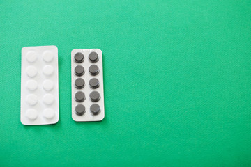 pills in blisters  on green background