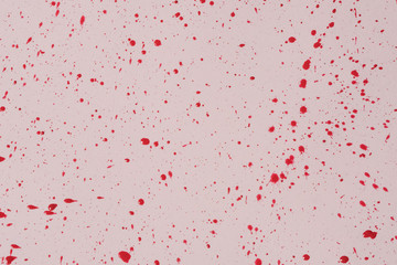 Obraz premium Red watercolor drops on a pink background.