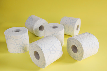 
toilet paper isolated on yellow background
