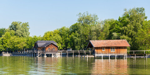 Fototapeta na wymiar Wooden boat houses at Ammersee (Lake Ammer) duing springtime