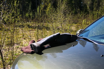 Rubber boots are dried on the car