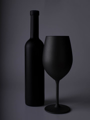 Wine glasses on black backround and wine bottles