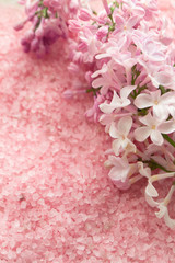 Lilac flower and bath pink salt top view background, background for wedding card