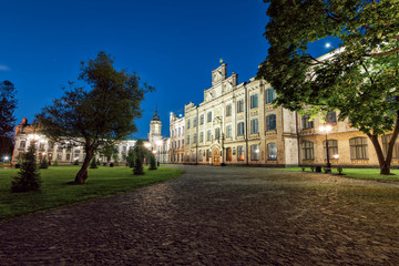 Fototapeta na wymiar The main campus of the university, famous places of Kiev, the old building in the evening, the building of the Kiev Polytechnic Institute, a summer evening in the park