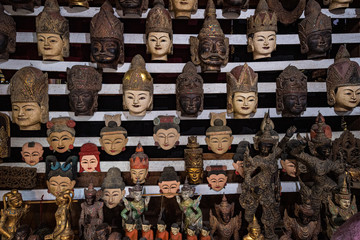 Carved wooden masks on sale in Mandalay, Myanmar