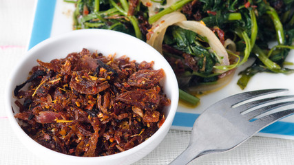 Appetizing Spicy Maldives fish dish  - (dried fish sambal)  with leafy green water spinach (Kankun )stir-fries. Asian food kitchen.