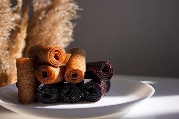 Fruit leather of apples and berries in rolls (Russian pastila). Background for text and articles on...