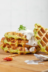 Proper breakfast, healthy Belgian waffles from zucchini with sour cream. On white background.
