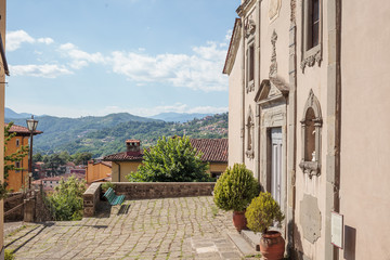 Beautiful view of tuscan hills in front of church in Barga, Tuscany, Italy