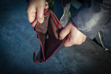 street lighting. Bright sun. A hand opens a wallet and it is empty. Close-up.