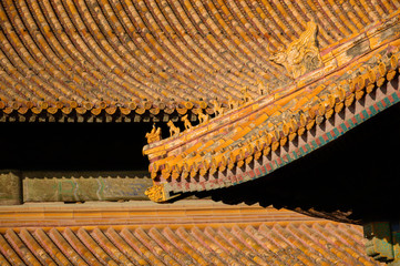 Richly decorated roofs of a Chinese temple, small colorful details with figurines.