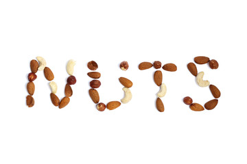 Composition of the word nuts from nuts. Cashews, hazelnuts, almonds. On white background.
