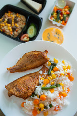 Food delivery. Fried fish with rice and other colorful food on a white background. Food concept. 