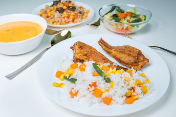 Fried fish with rice and other colorful food on a white background. Food concept. 