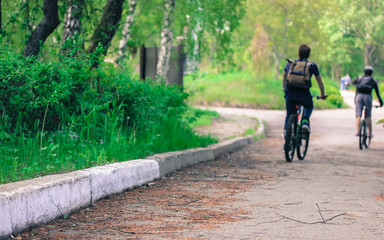 Fototapeta premium A man riding a bike down a dirt roadundefined