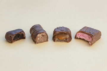 Halves of chocolates of different tastes. Mix of sweets with different fillings.