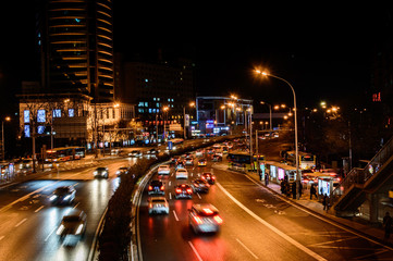 Beijing at night, driving cars on a busy road in the city.