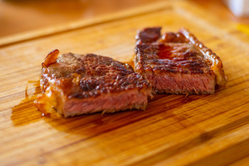 Shots of a sliced fresh rump steak with fat on  the steak on a wooden board