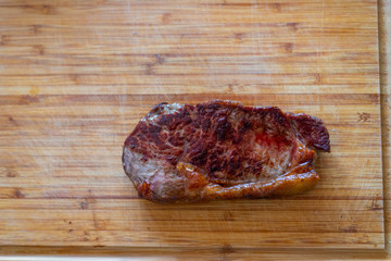 Shots of a sliced fresh rump steak with fat on  the steak on a wooden board