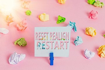 Word writing text Reset Realign Restart. Business photo showcasing Life audit will help you put things in perspectives Colored crumpled papers empty reminder pink floor background clothespin