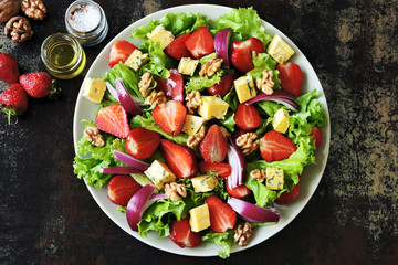 Fresh tasty salad with strawberries and cheese. Summer diet. Healthy fitness salad.