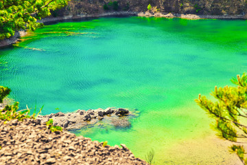 Azure lake. The concept of landscape and relaxing in the fresh air. Trukus water reservoir, attraction and a beautiful place to spend free time. Beautiful forest and water landscape.